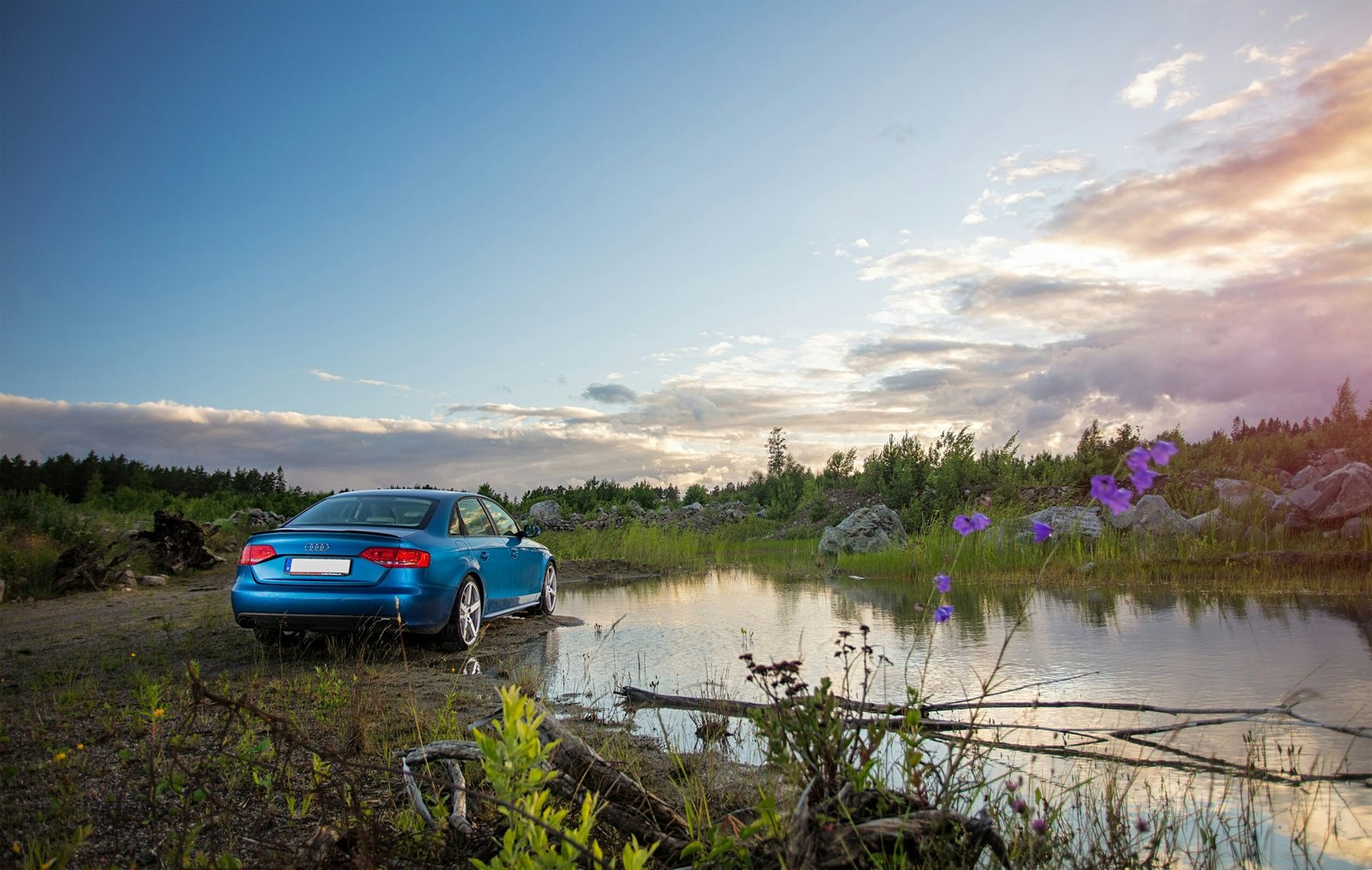 red chevrolet camaro on lake